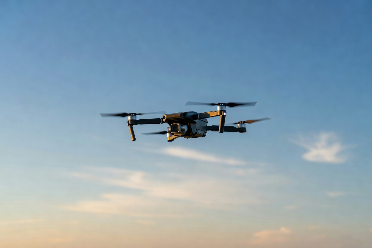 Quadcopter with camera flying in open sky, illustrating the Potensic Atom SE